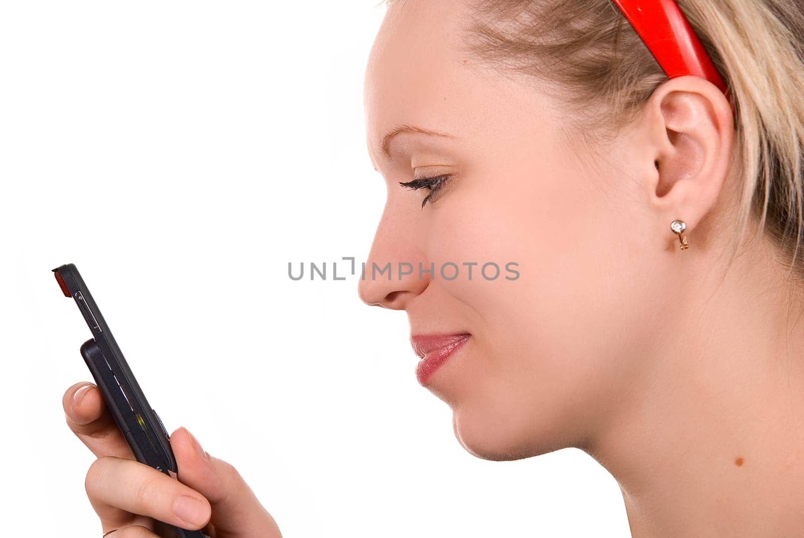 Girl in red hair band with mobile phone on white