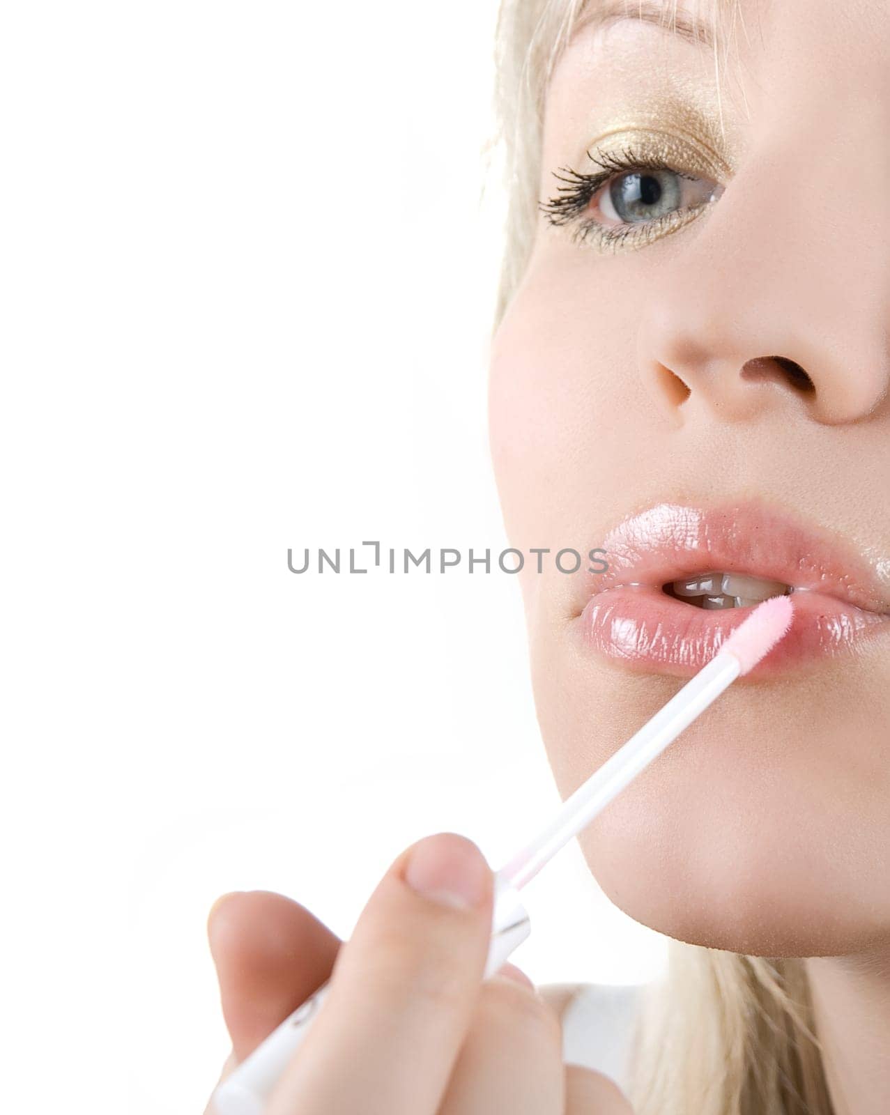 Pretty girl paint her lips on white