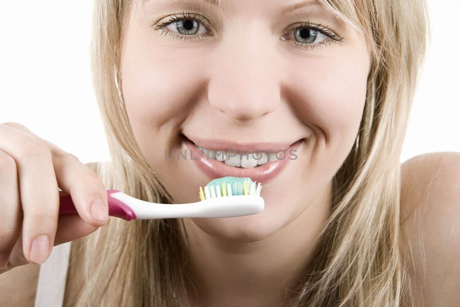 Young beautiful smiling woman with white teeth holding a tooth brush