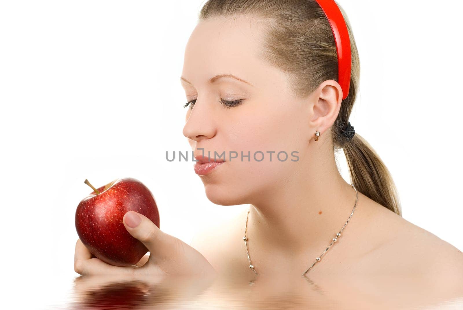 Pretty girl with apple isolated on white
