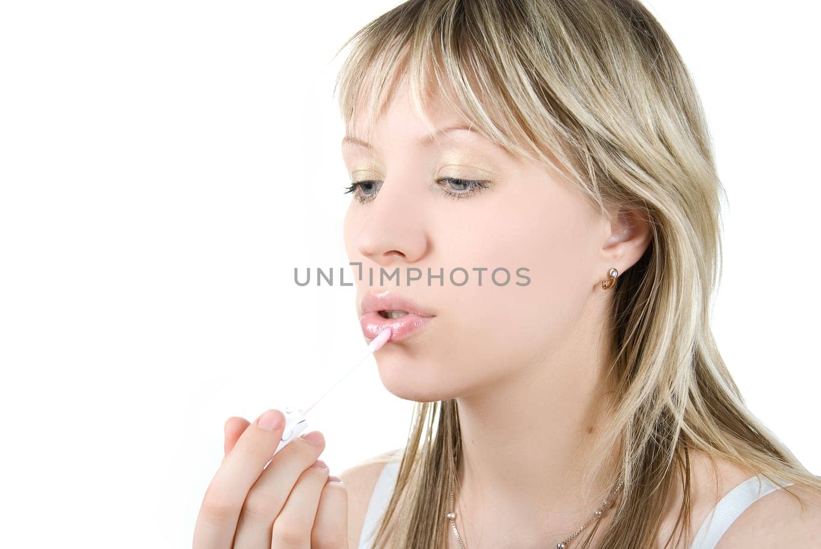 Pretty girl paint her lips on white