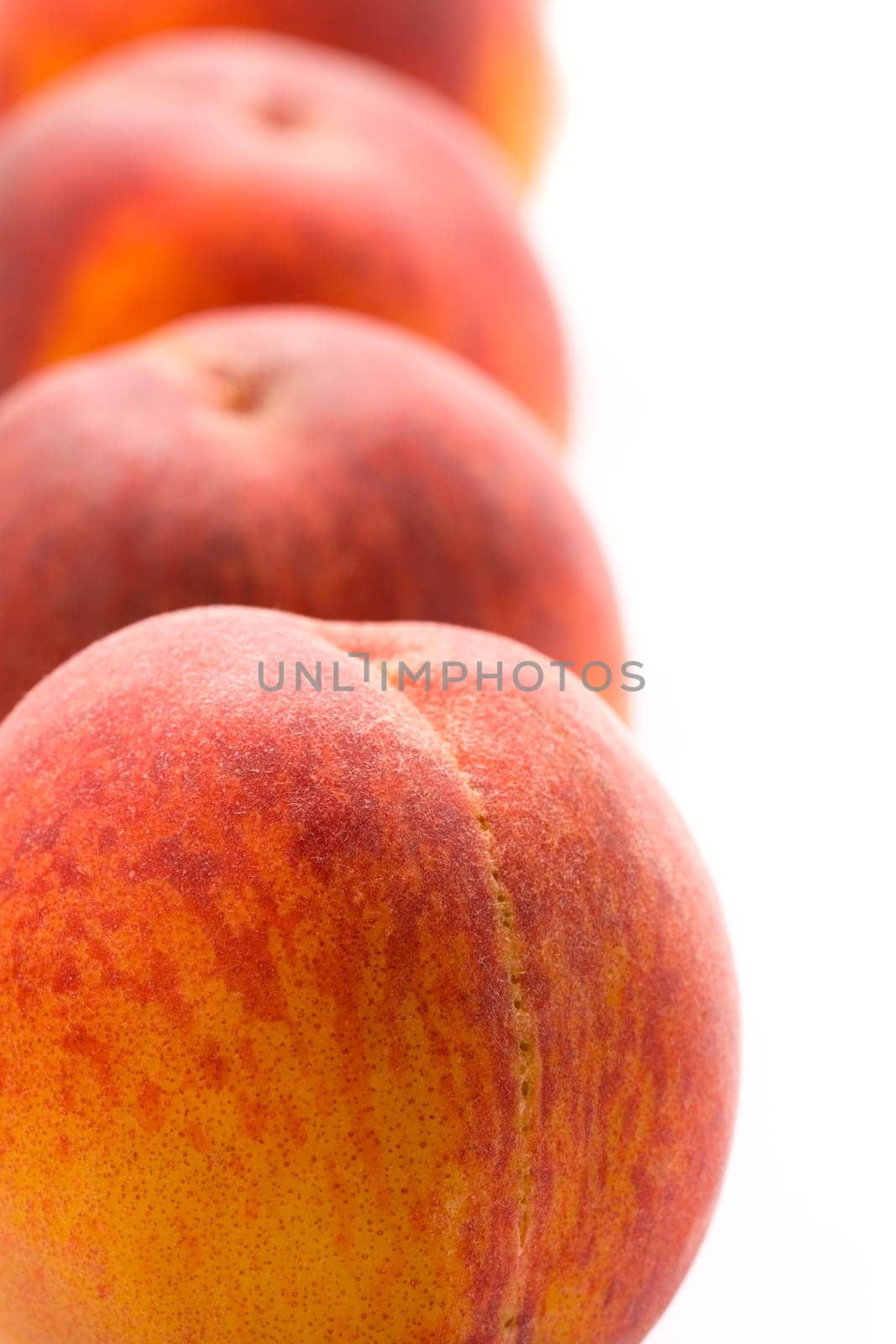 four peaches closeup on white background