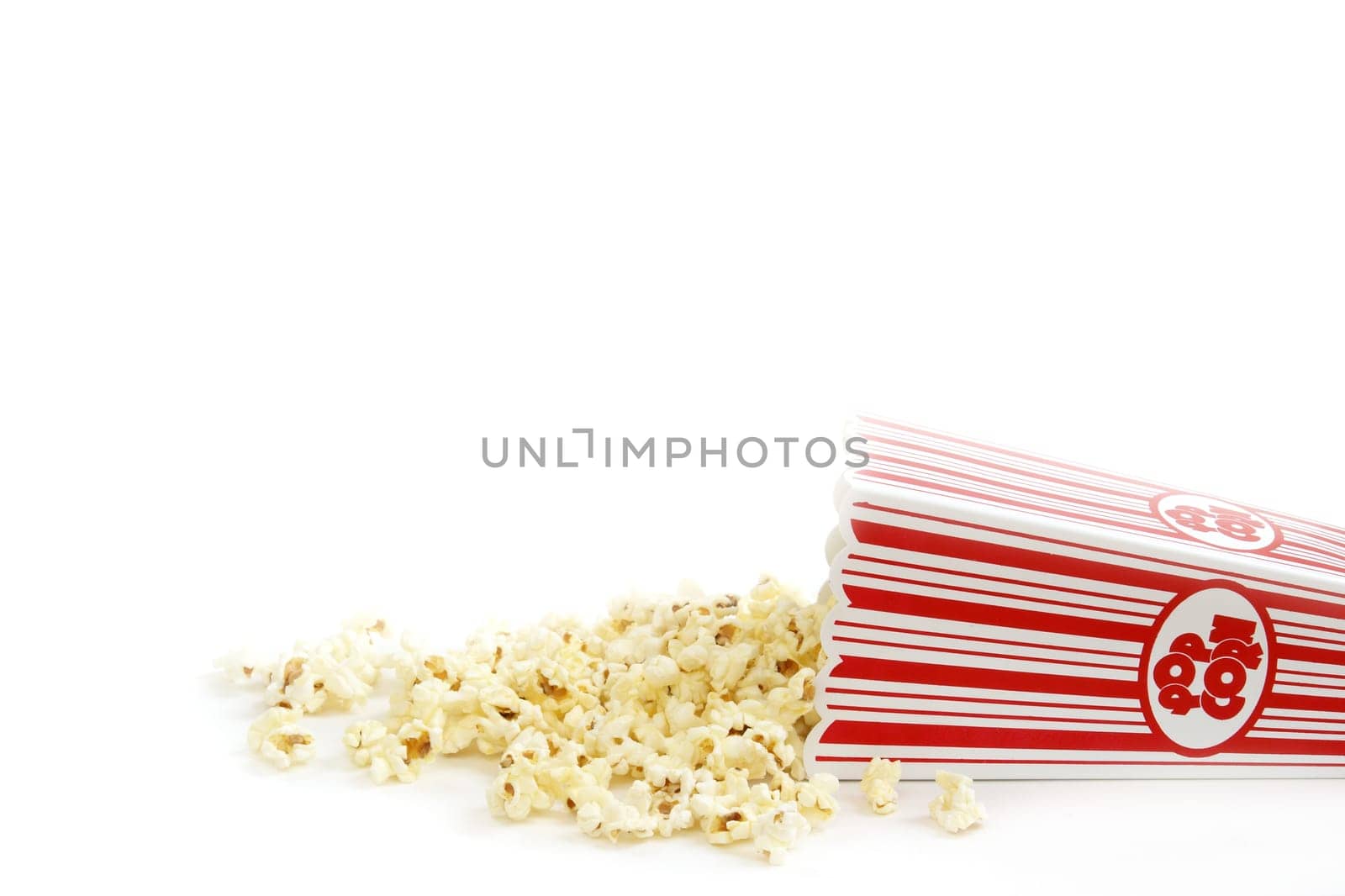 A bucket of popcorn has spilled out.