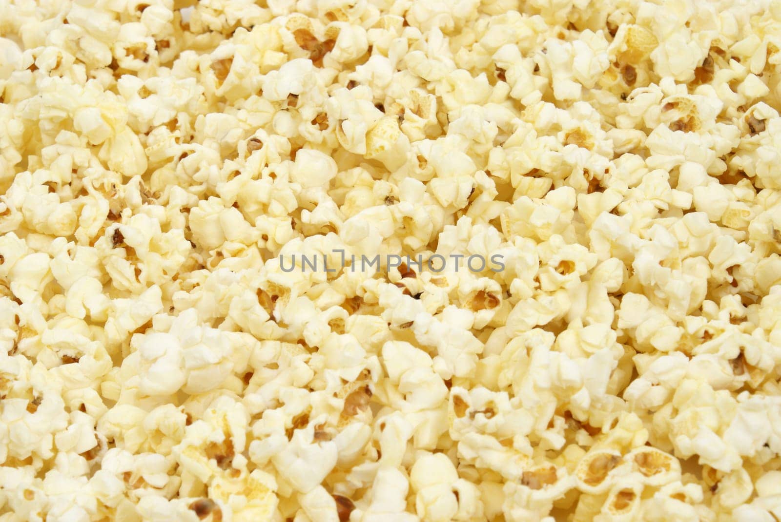 A macro shot of popcorn that is filling the frame.