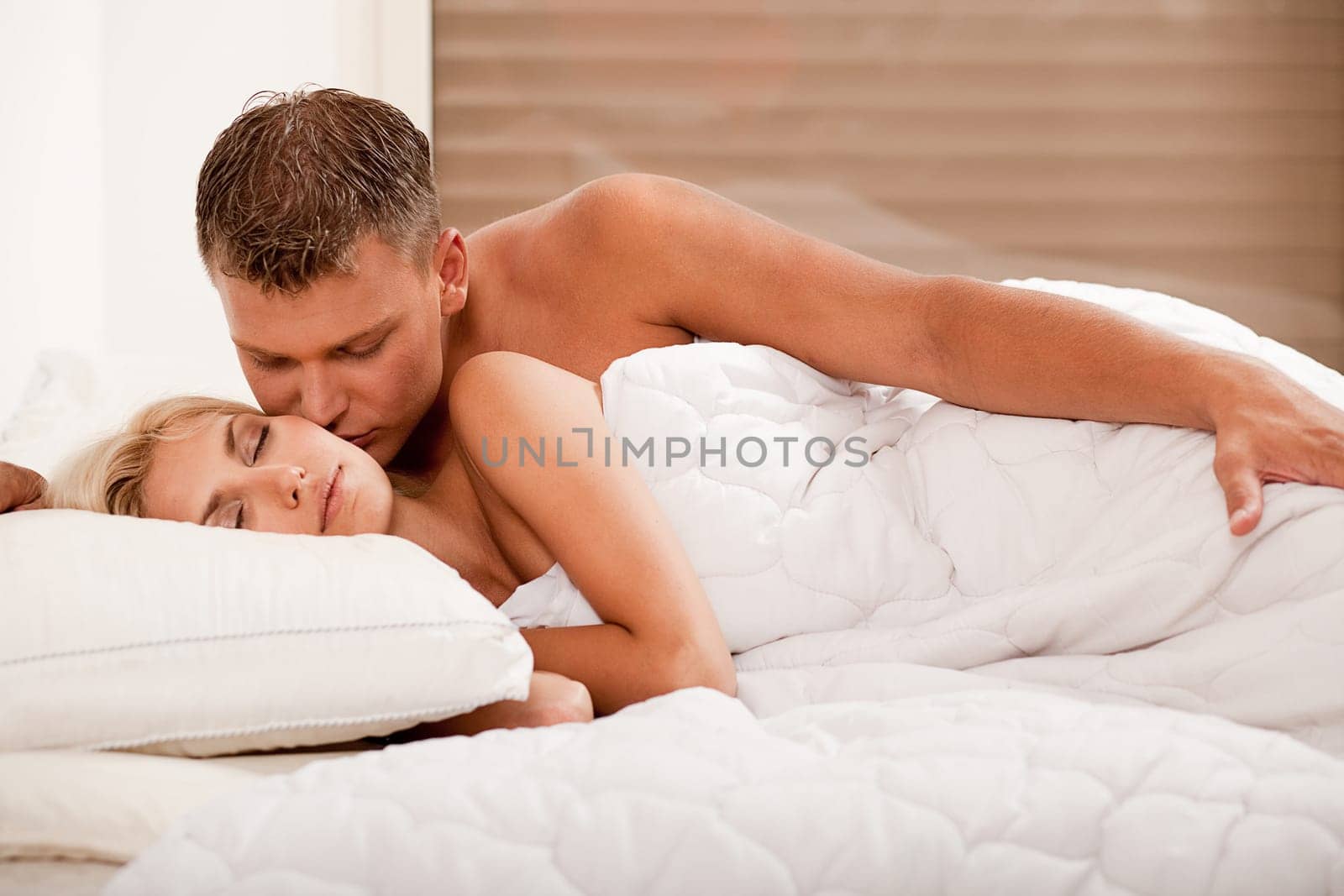 Affectionate man kissing his wife