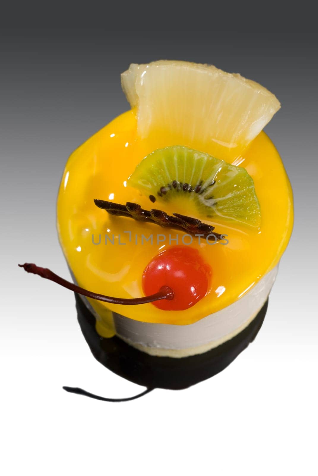 piece of fresh fruit cake close up over black reflective surface
