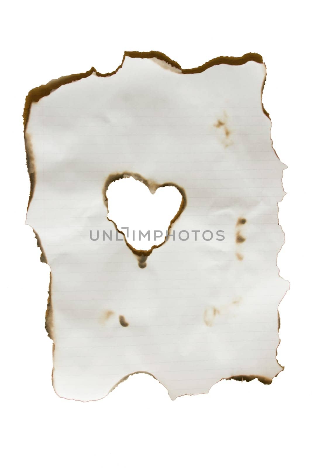 An isolation of a burned piece of paper with a heart at the center