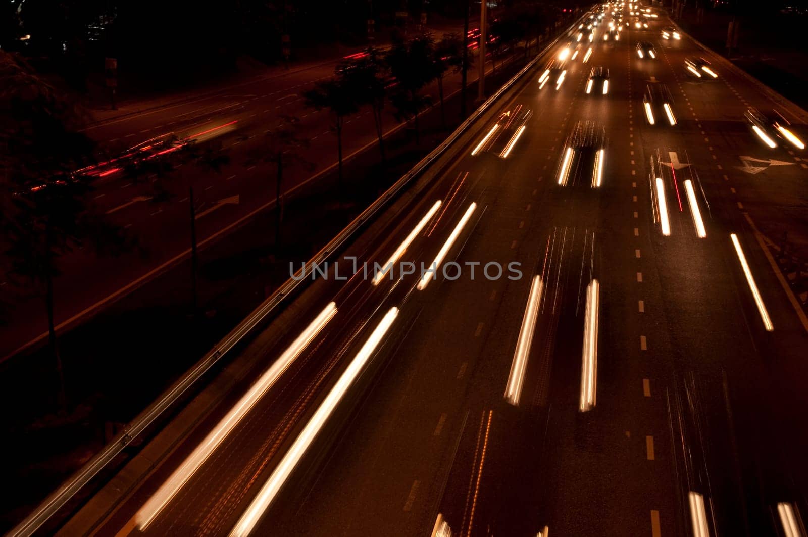 Cars moving on busy roads at night.