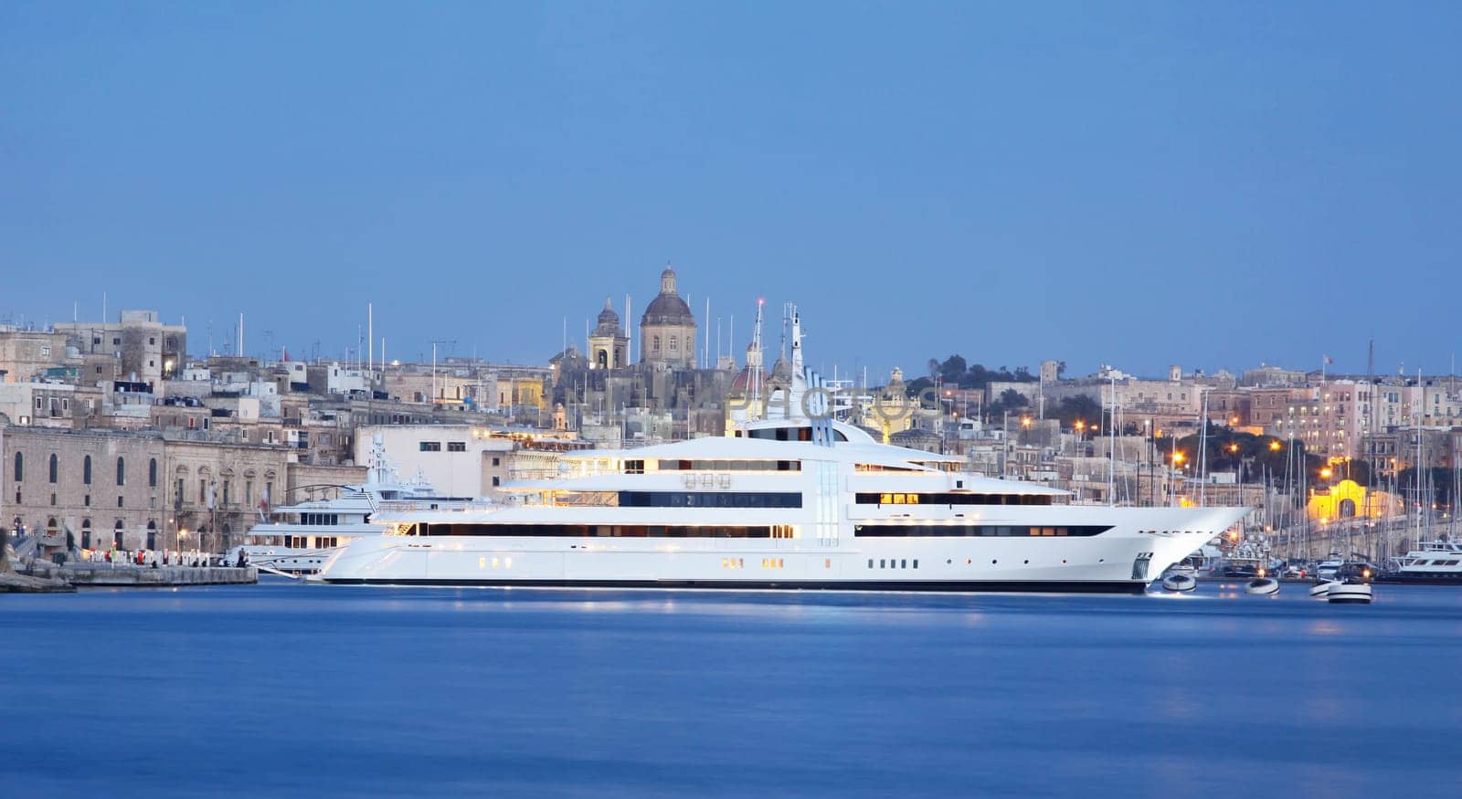 a super yacht berthed in a marina in malta