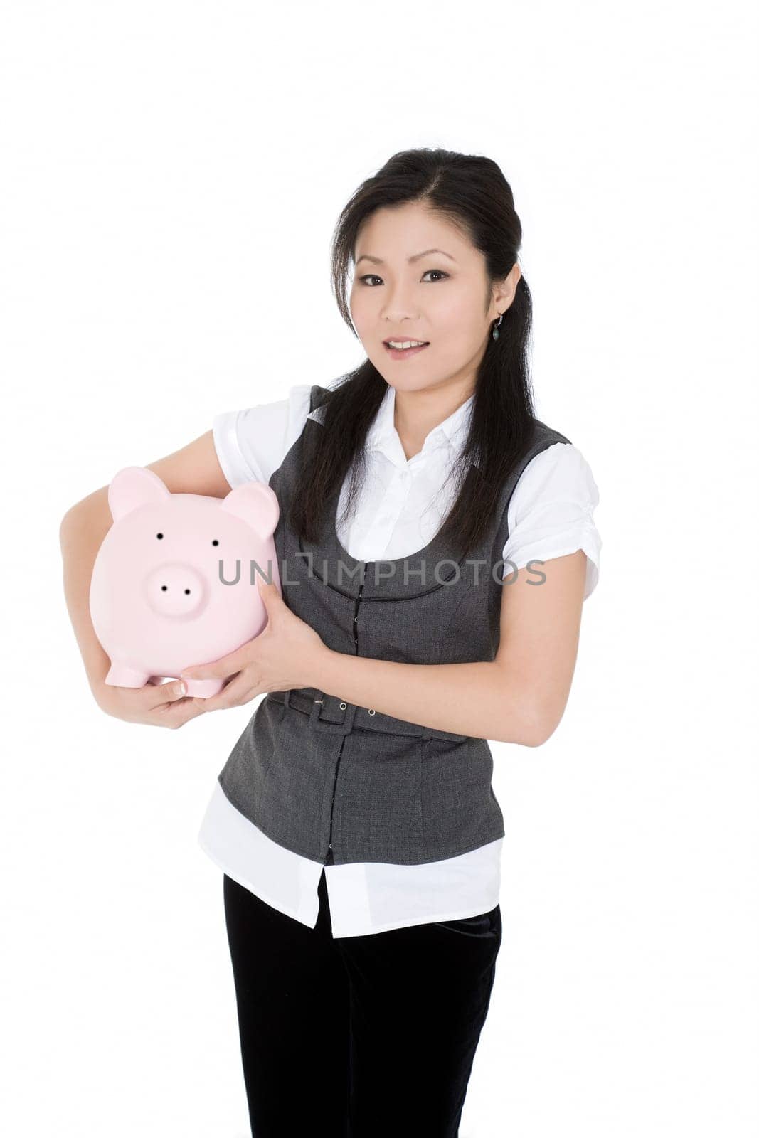 Beautiful Asian businesswoman holding a piggy bank