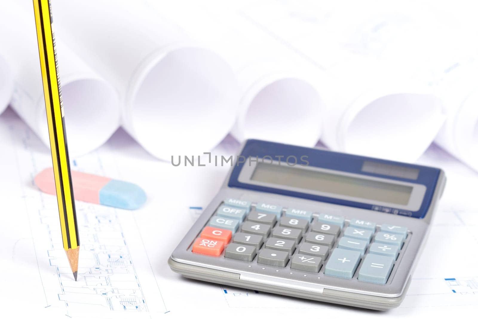 Construction plans, calculator and drawing tools. Shallow depth of field
