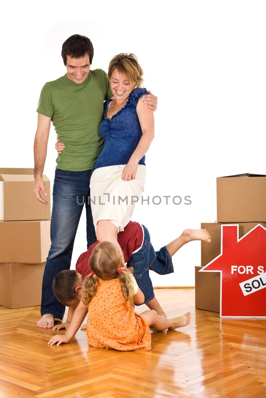 Family with kids having fun in their new home on the floor - isolated
