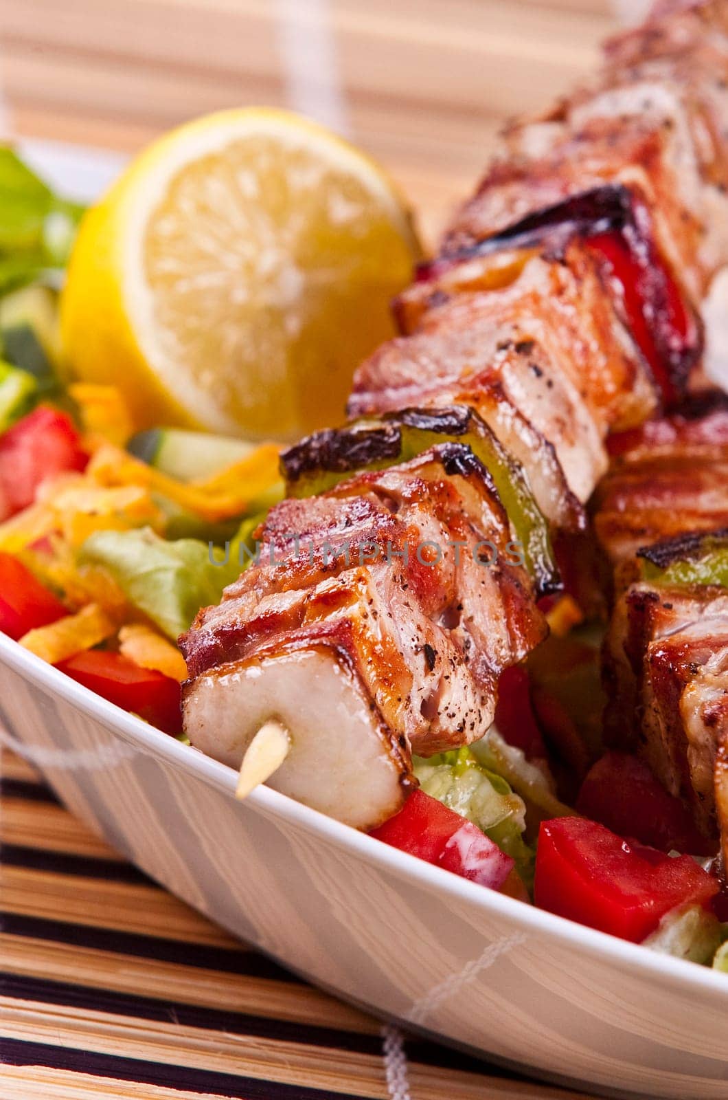 Grilled chicken kebab served with a fresh salad