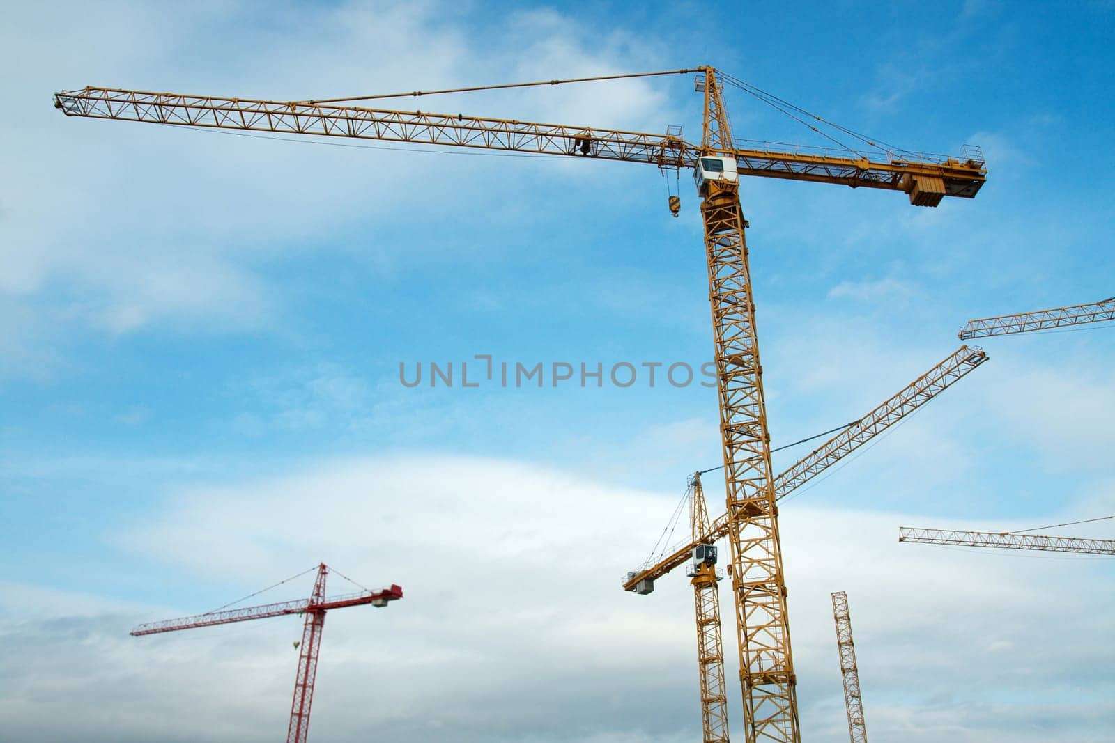 Tower cranes against blue sky