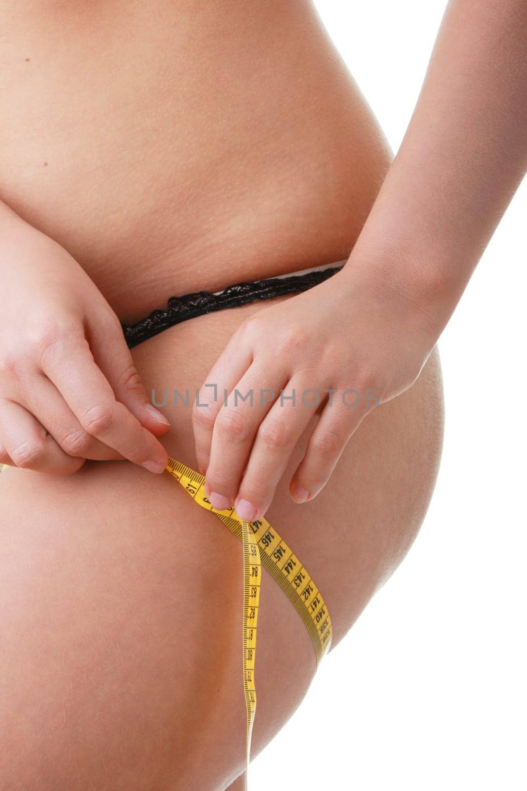 A little bit fat young woman mesuring her body isolated on white background