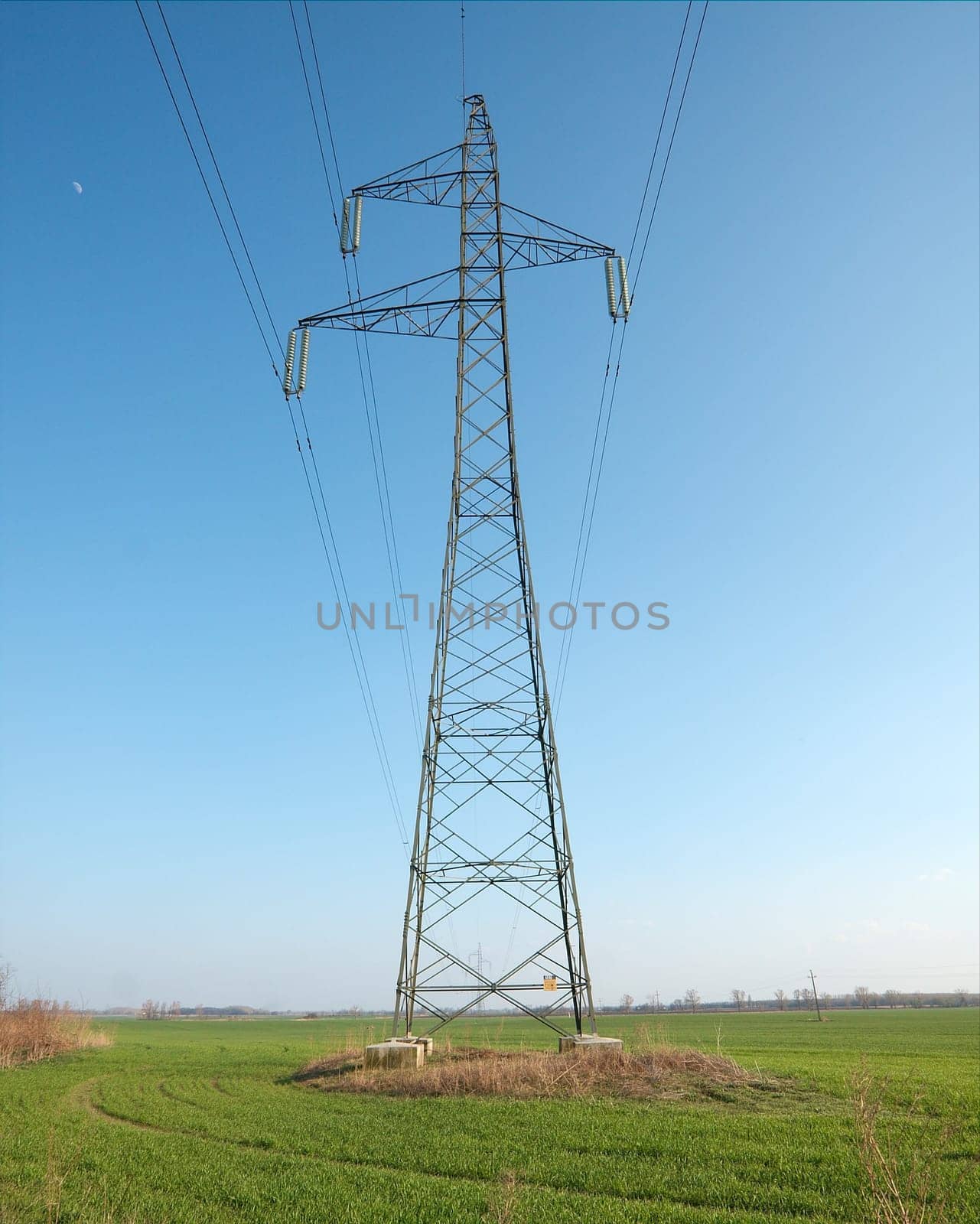 High voltage electric pillar over an agricultural field