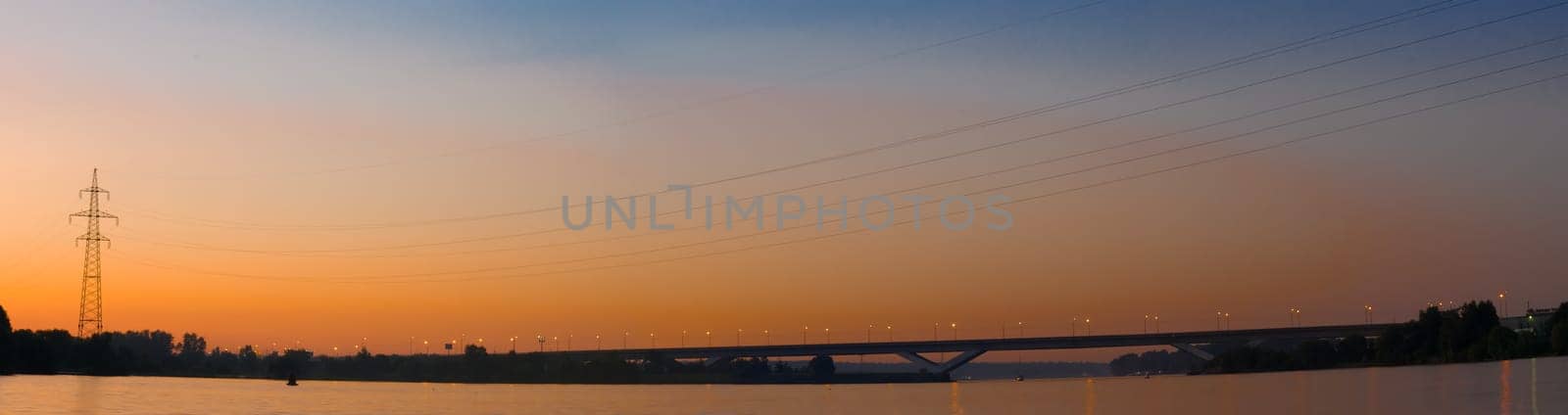 Panorama of the bridge against the sunset sky