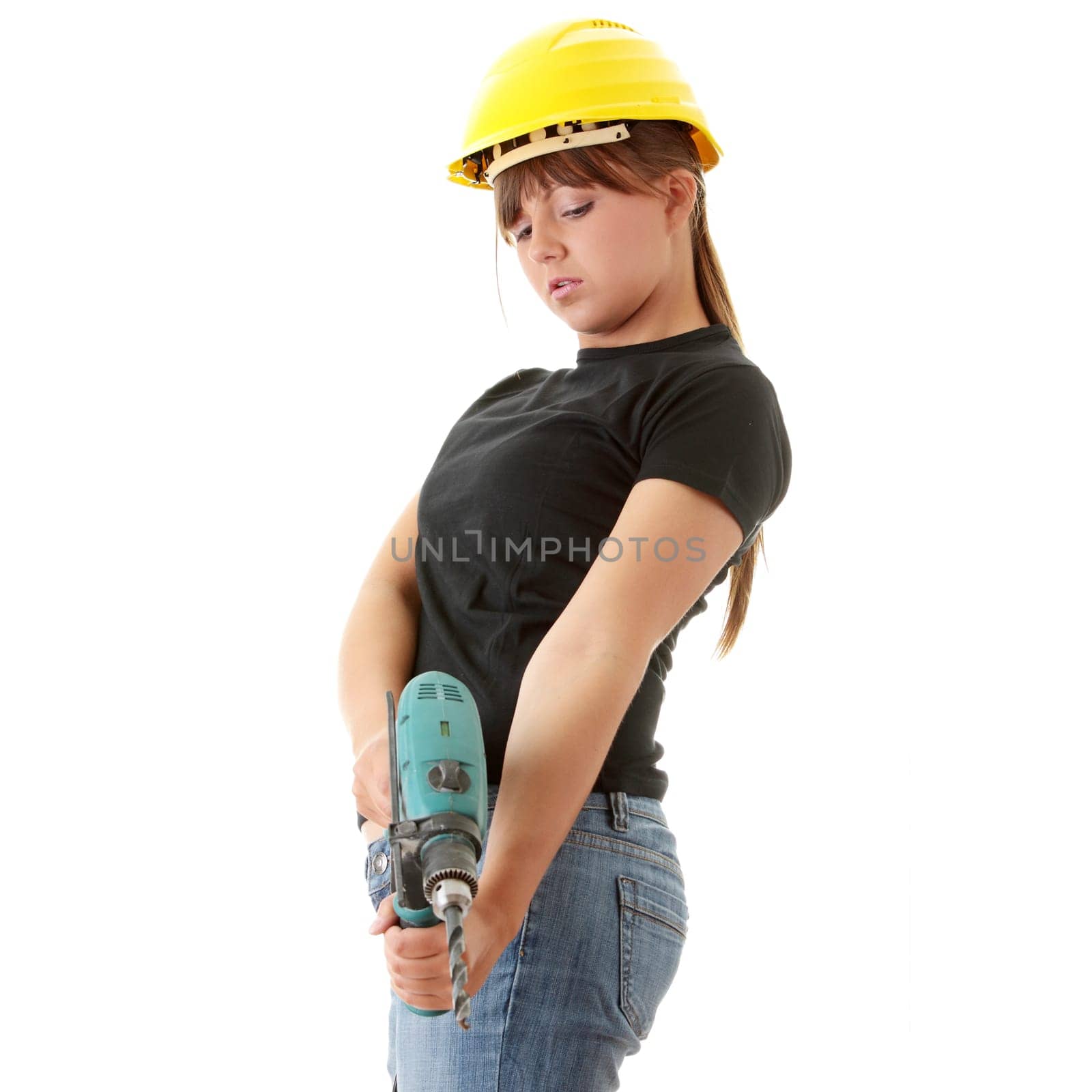 Young woman builder in yellow helmet holding driller
