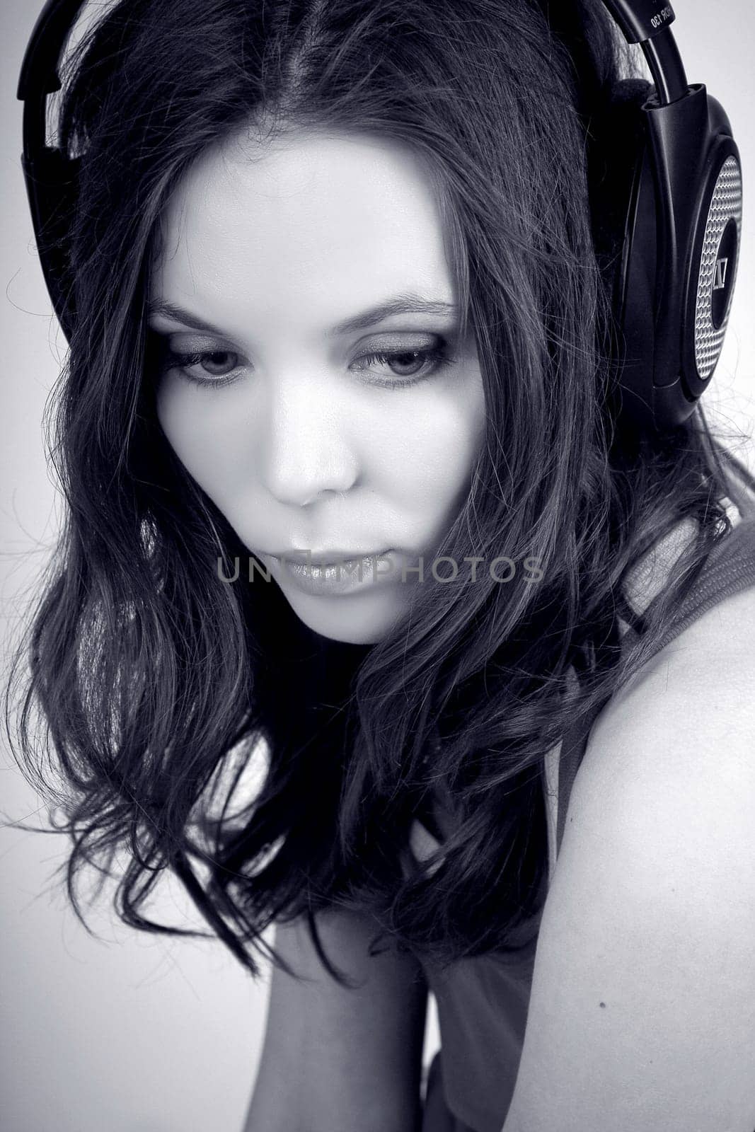 Monochrome portrait of charming young girl in earphones