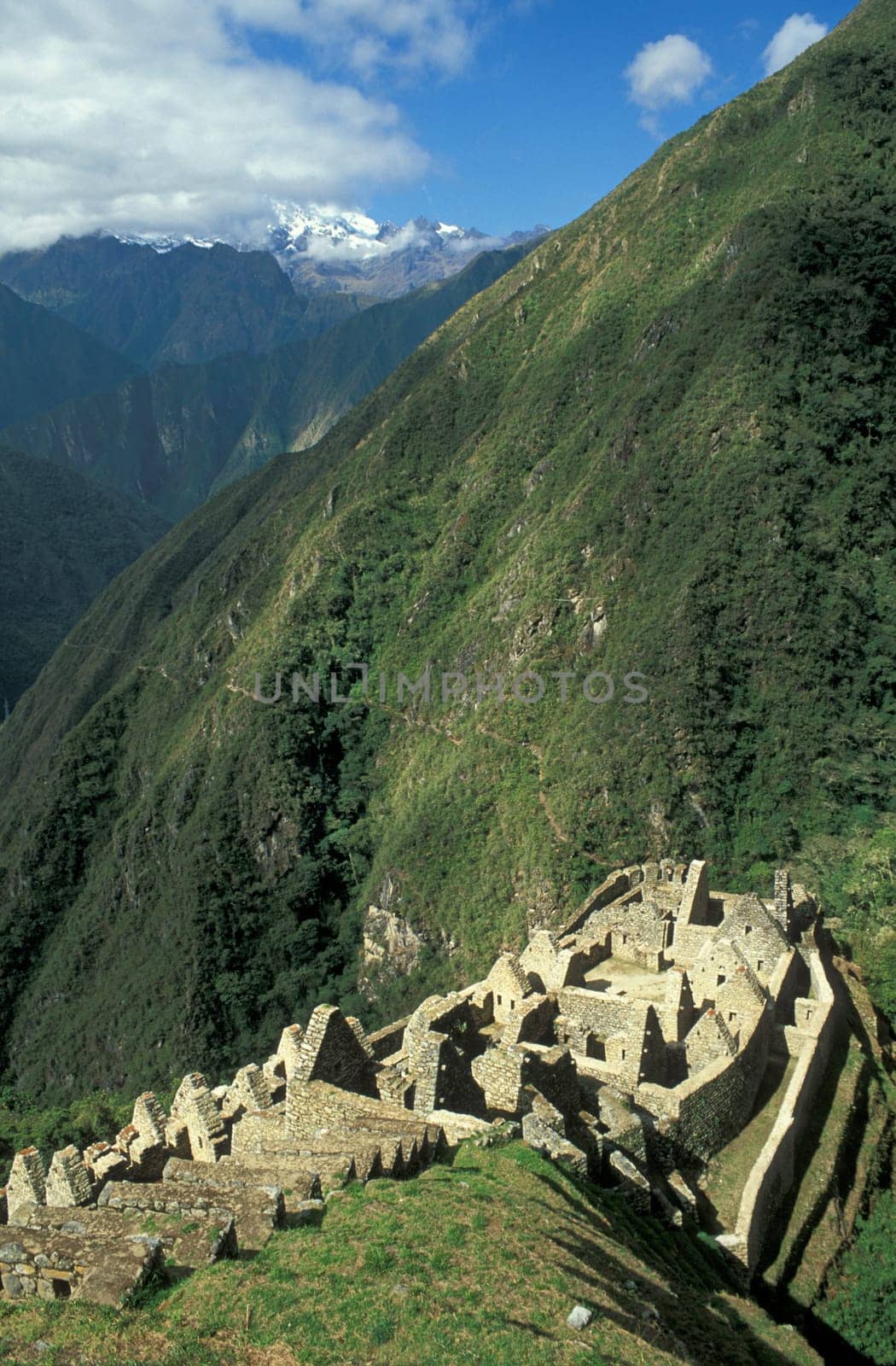 Long abandoned stone buildings of the Inca village of Winay Wayna high in the mountains of Peru