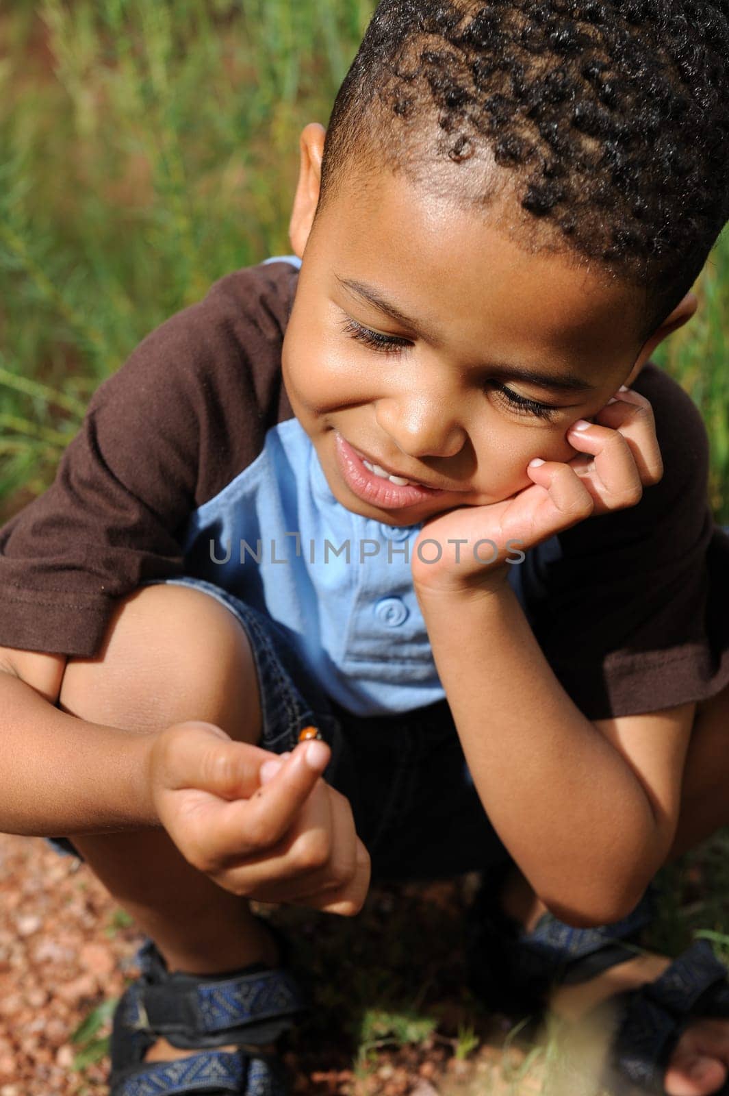 African American child playing in a meadow