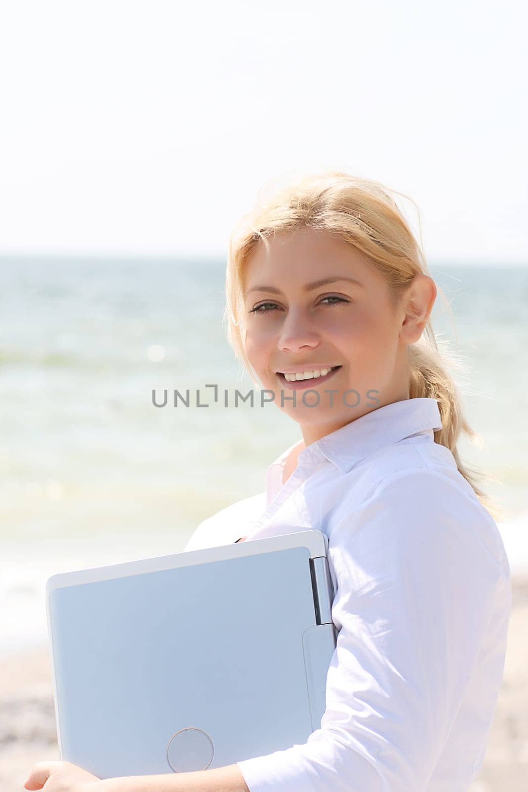 Young business girl holding laptop