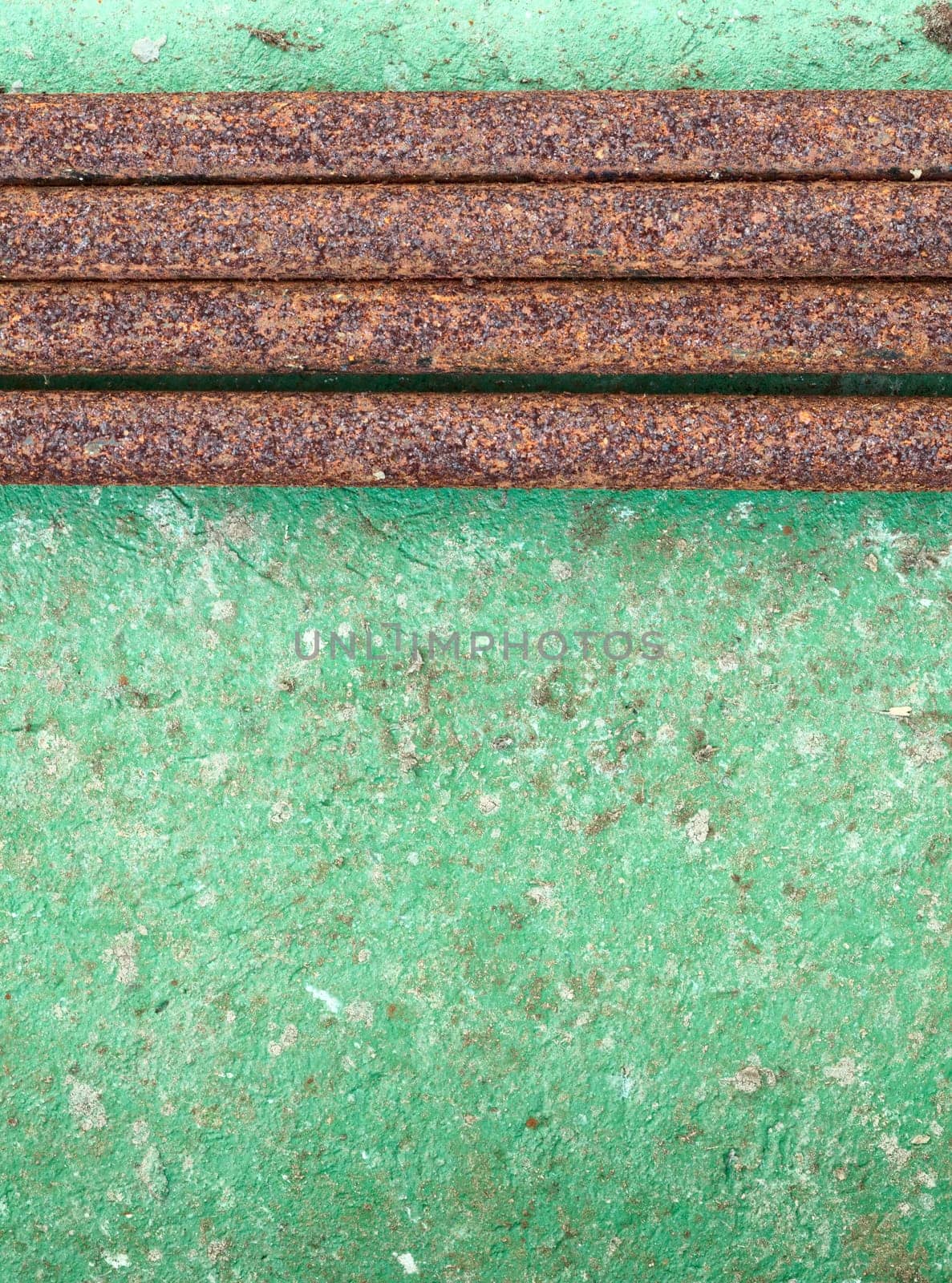 Old concrete painted wall with rusty iron pipes