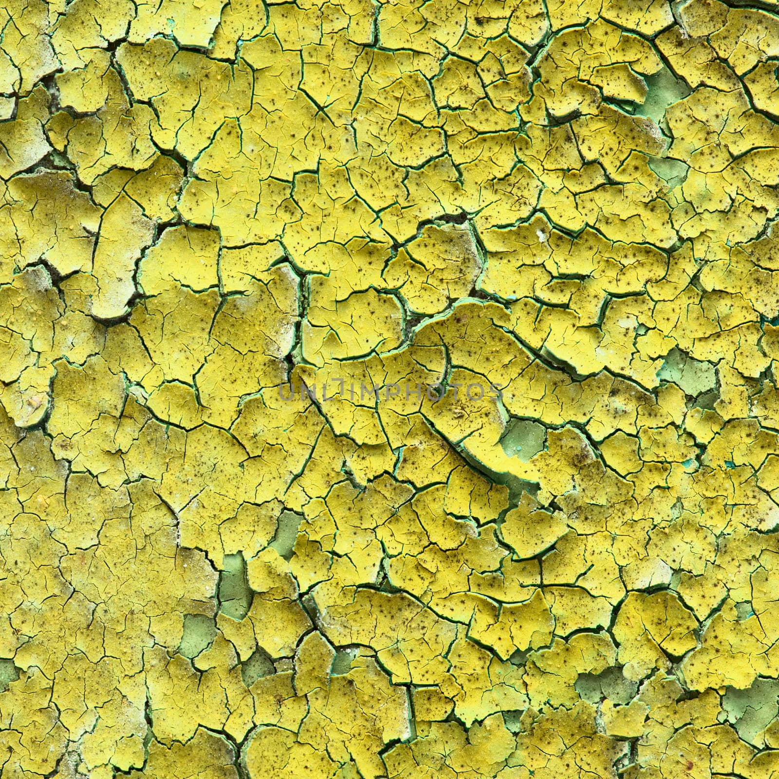 Old yellow wall with cracks and stains