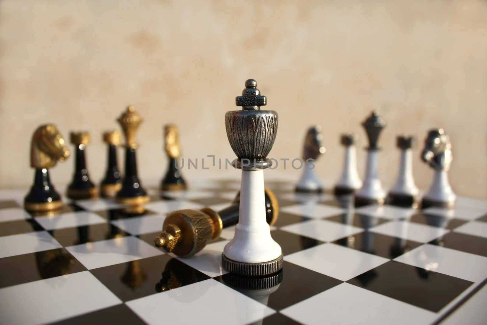 The end of a duel on a chessboard, the light wins the dark king is fallen