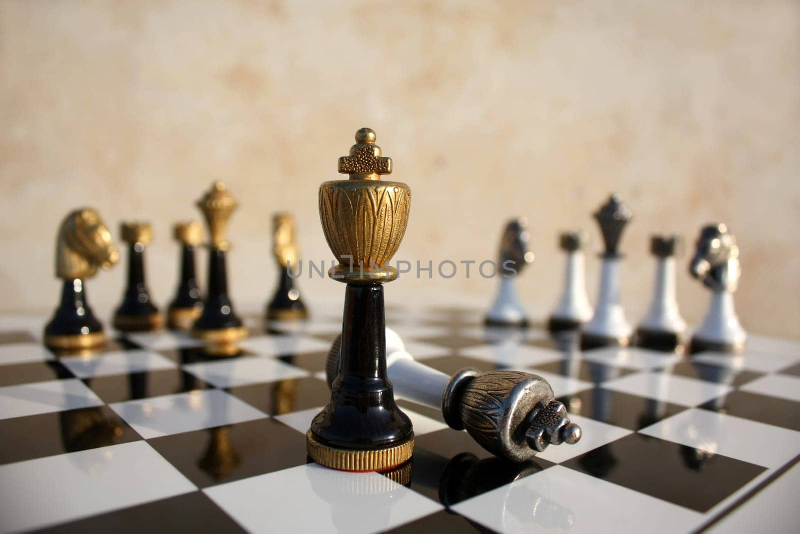 The end of a duel on a chessboard, the dark  wins the light king is fallen