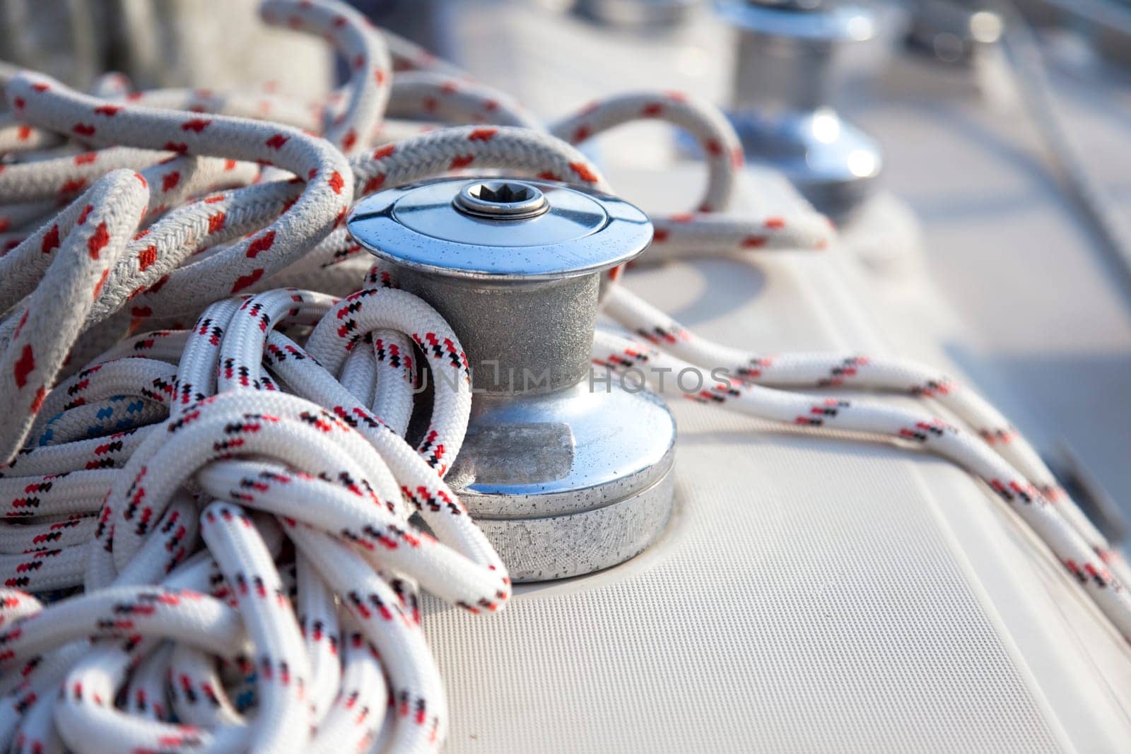 A close-up of a sail boat winch and bowline / yachting background