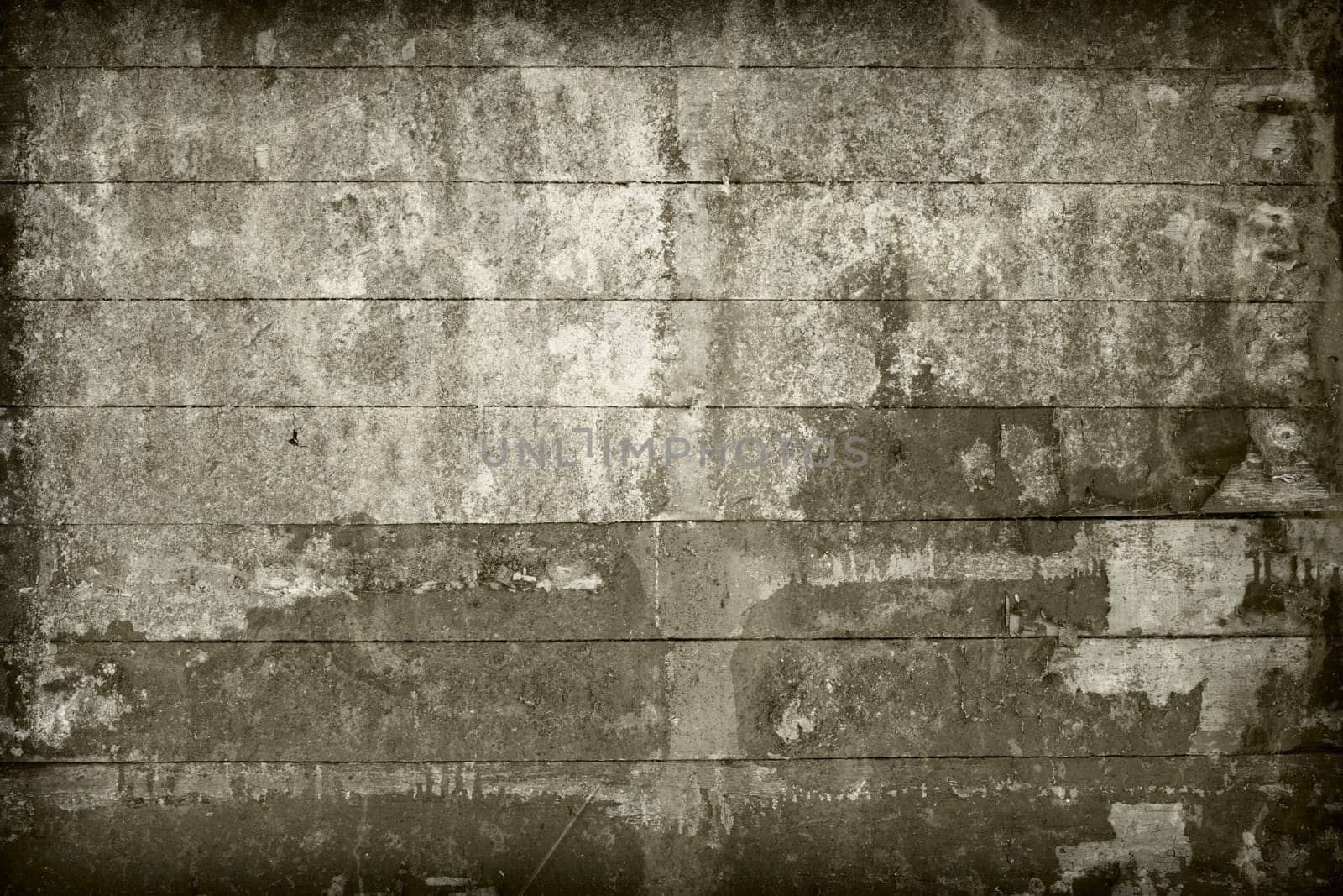 Surface of the old, brown wall covered with boards