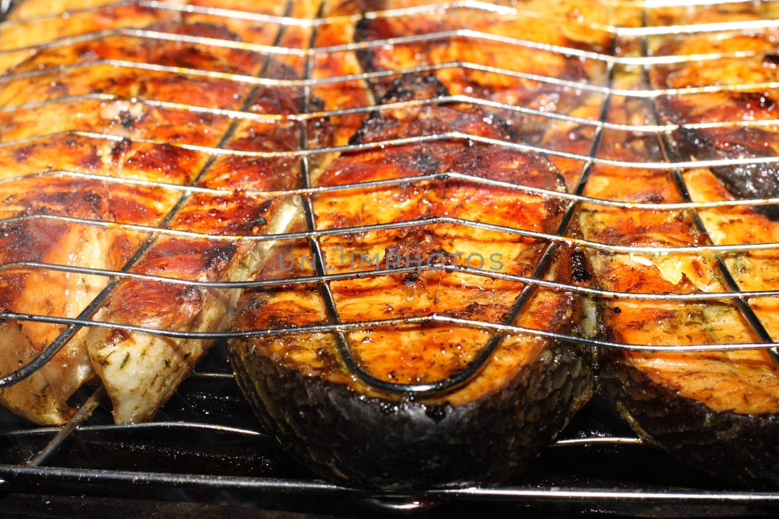 Salmon cooking on grill. Shallow DOF