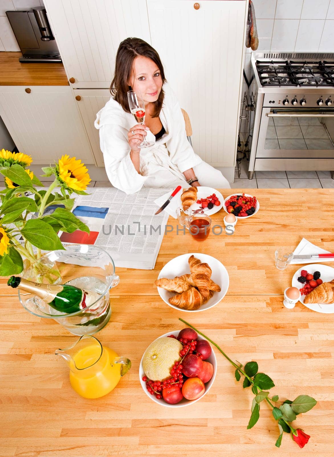 Young woman enjoying a rich champagne breakfast