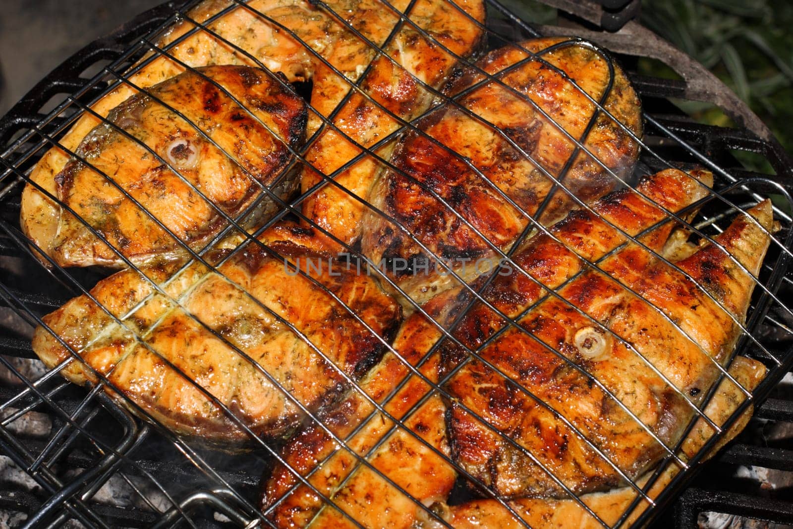 Salmon cooking on grill