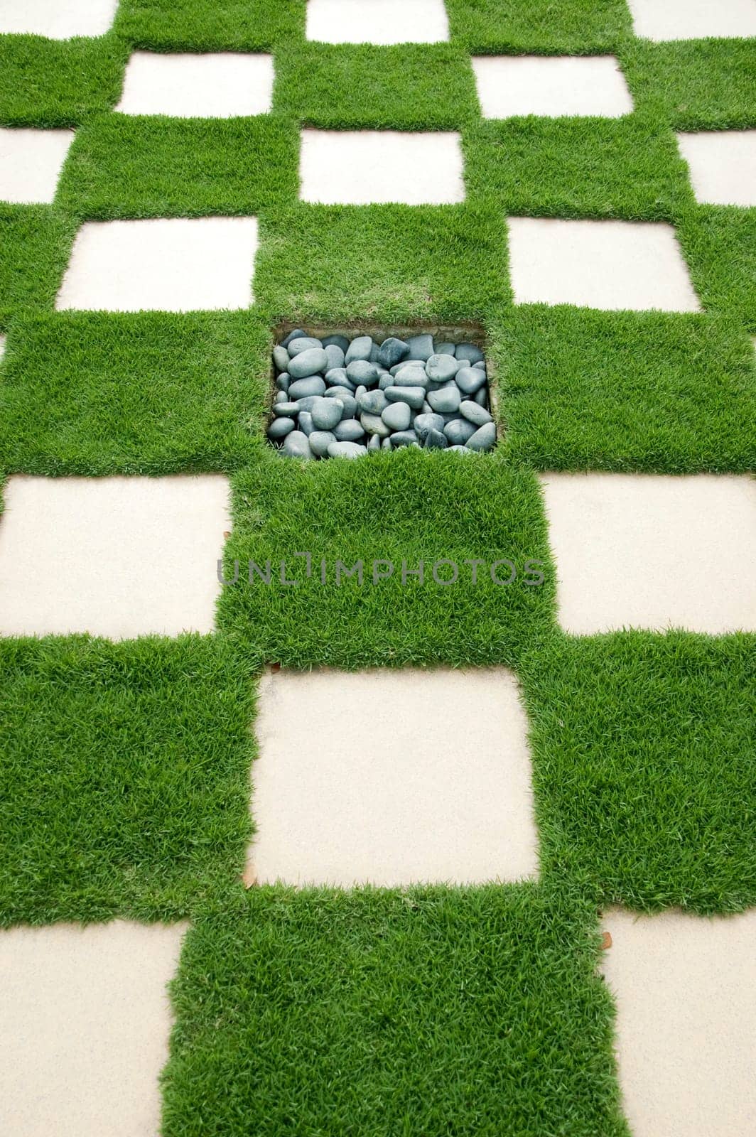 Brick with manicured lawn, with rock in the center.