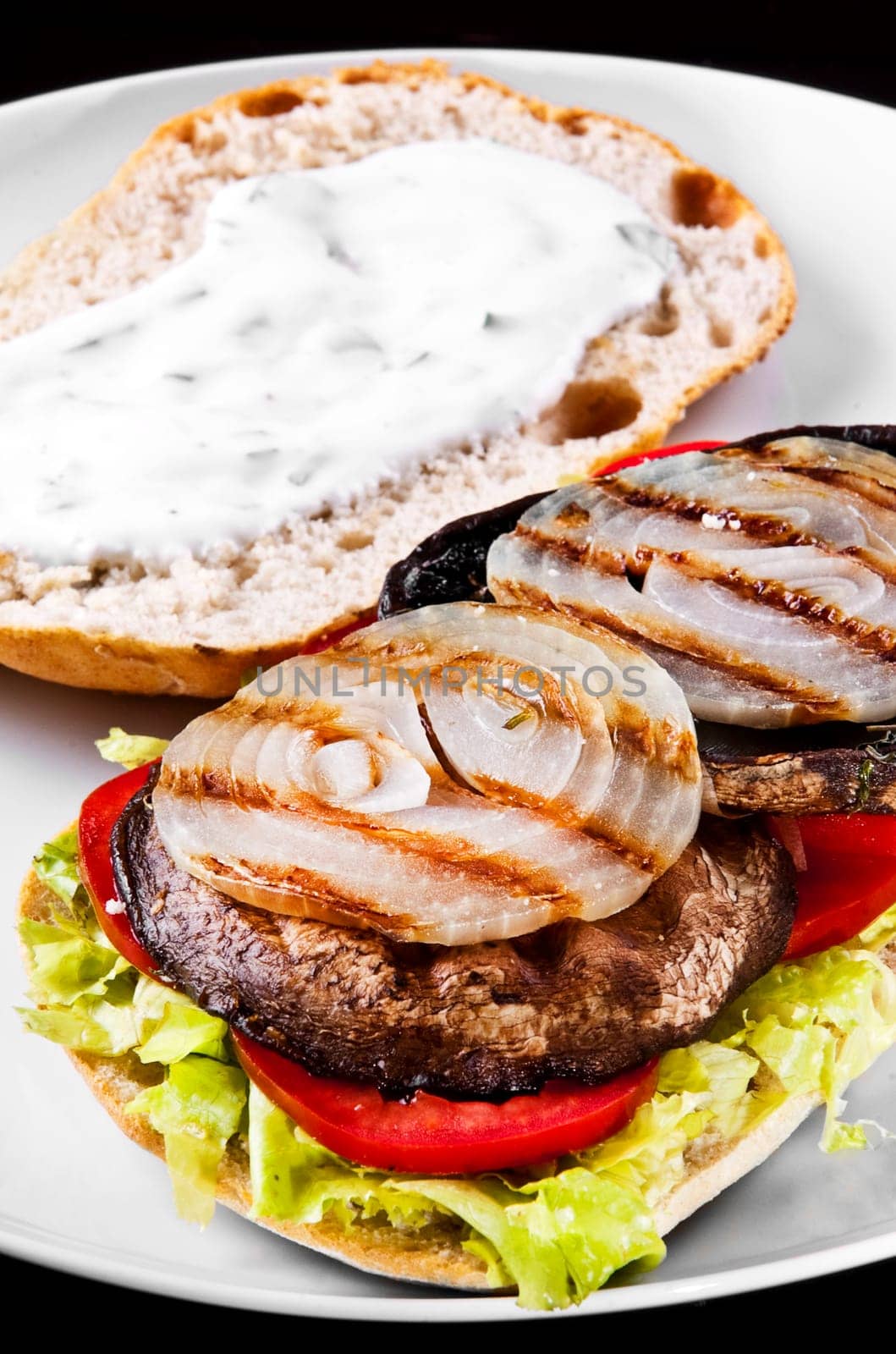 Portobello sandwich with grilled onion lettuce and tomato