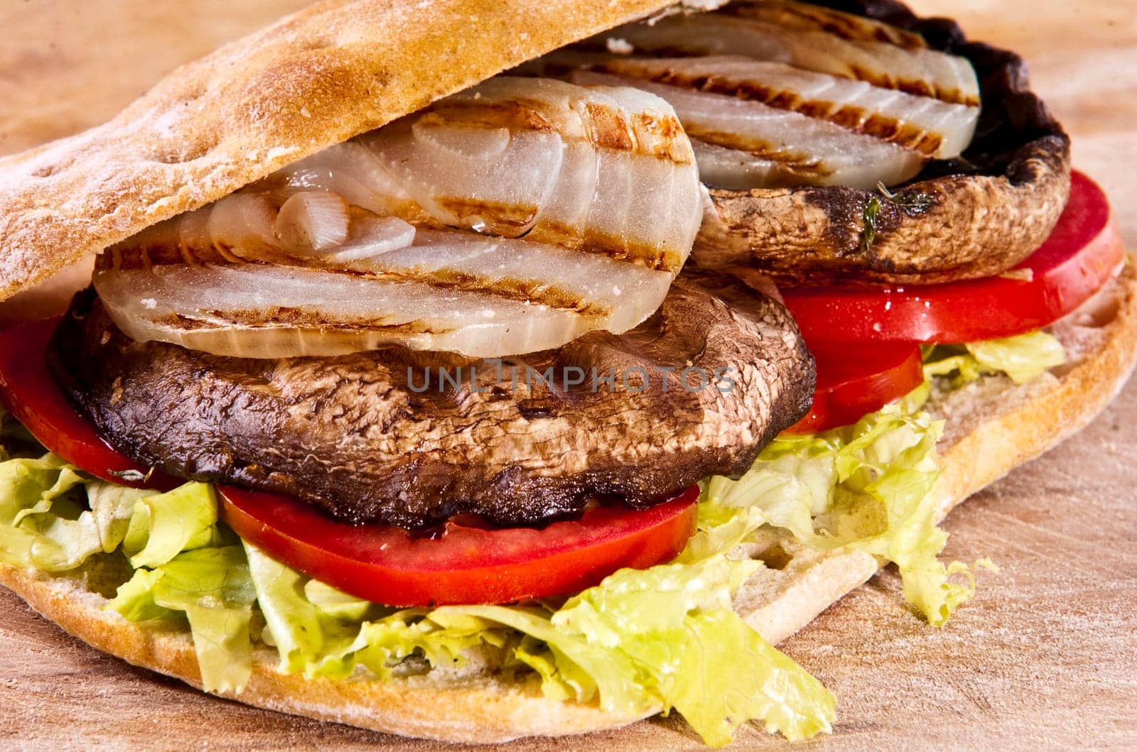 Portobello sandwich with grilled onion lettuce and tomato