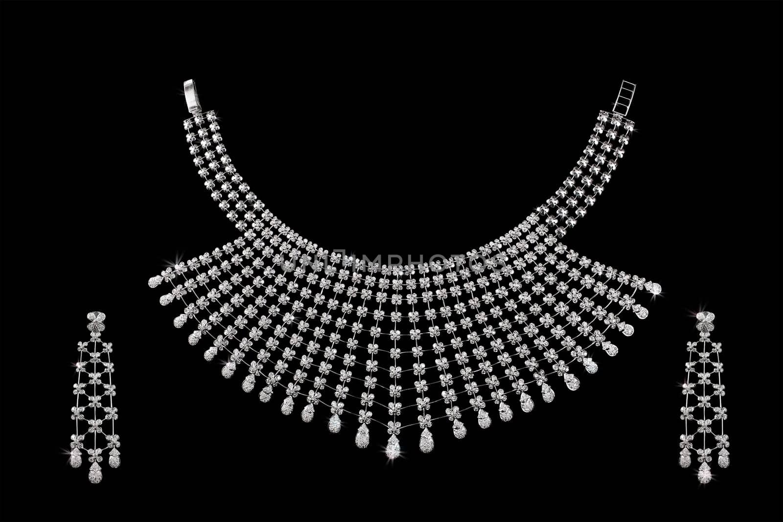 Diamond necklace on dark black background with ear rings