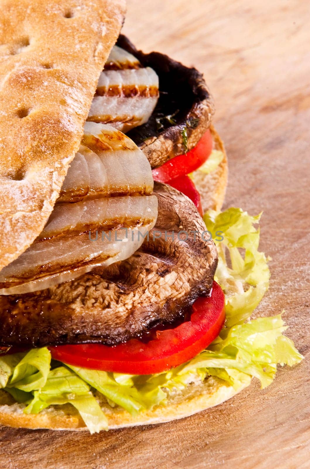 Portobello sandwich with grilled onion lettuce and tomato