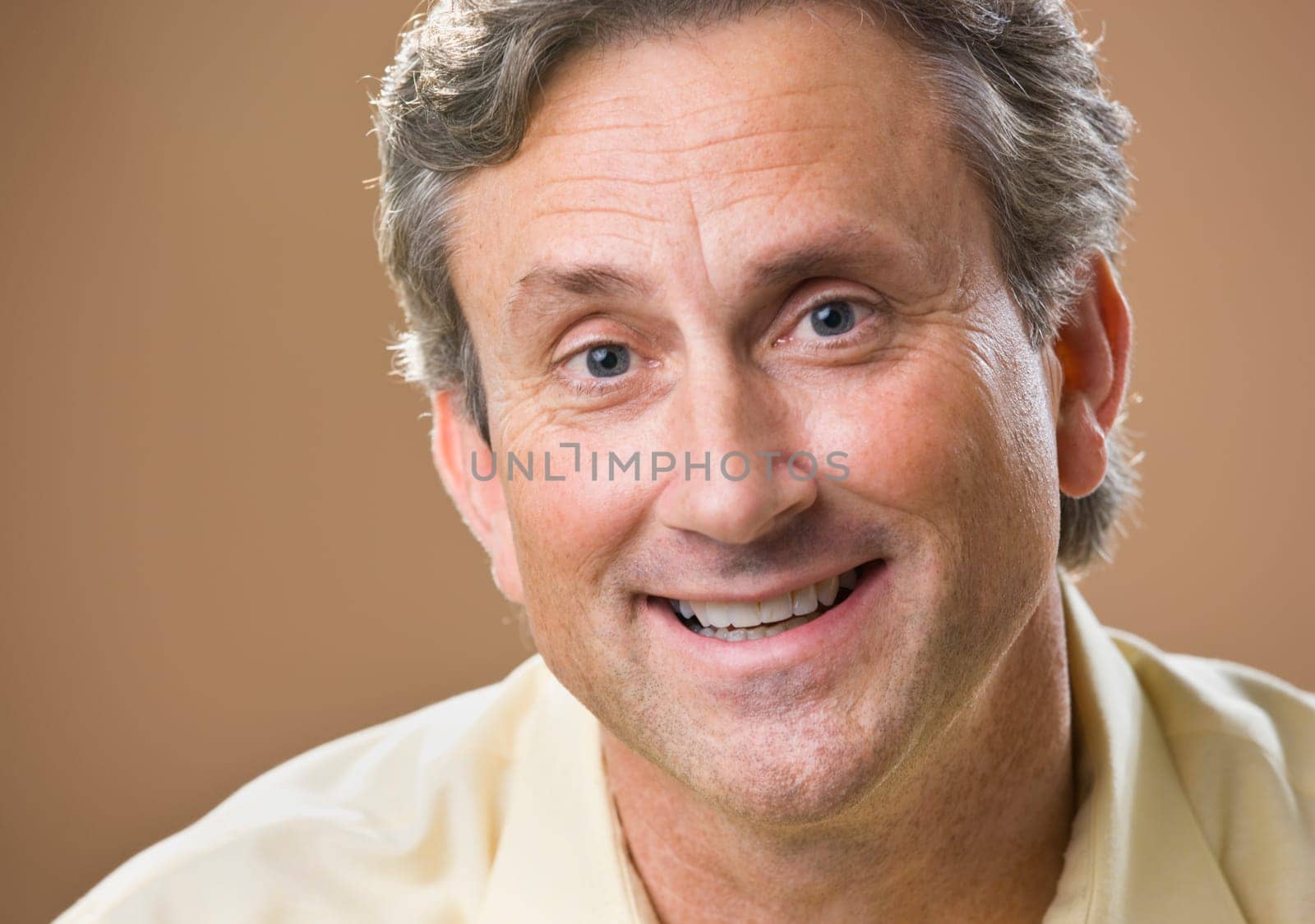 Attractive male smiling at camera. Headshot. Horizontal