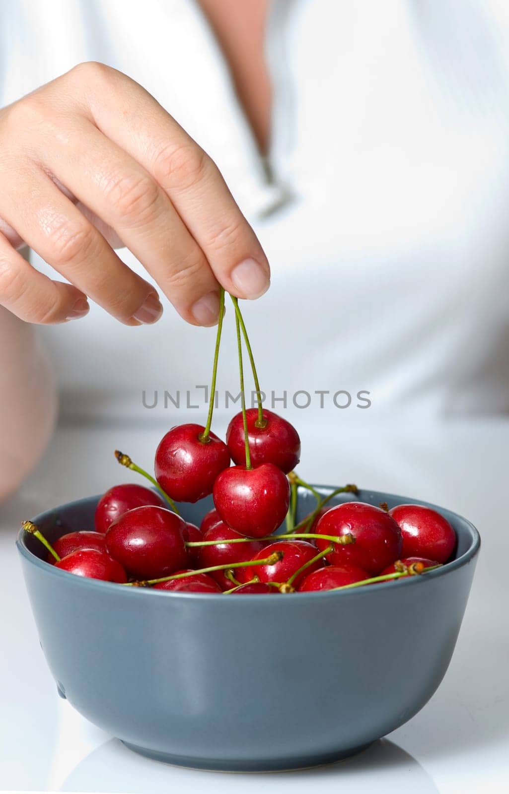 sweet cherry in woman fingers
