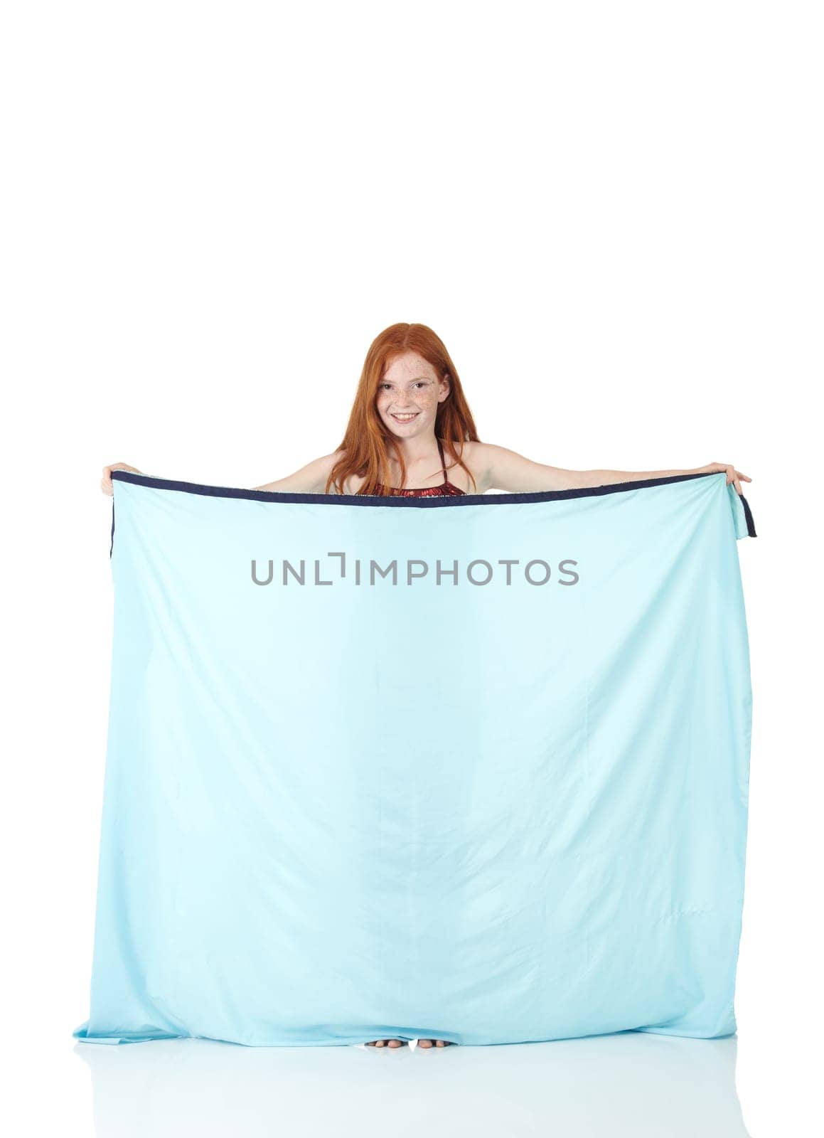 Young Caucasian belly dancing girl in beautiful decorated clothes on white background and reflective floor. Not isolated
