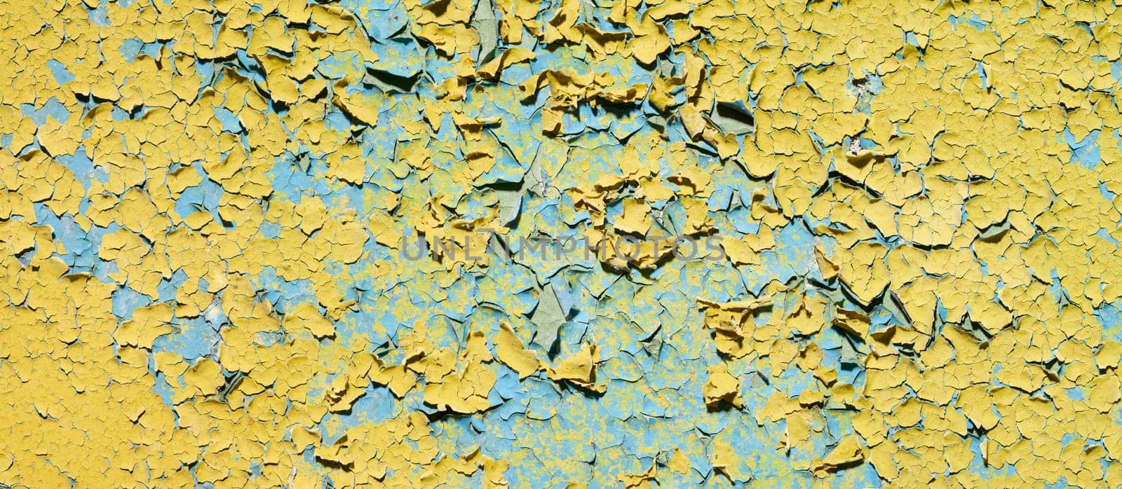 The old grunge cracked yellow wall of ruins