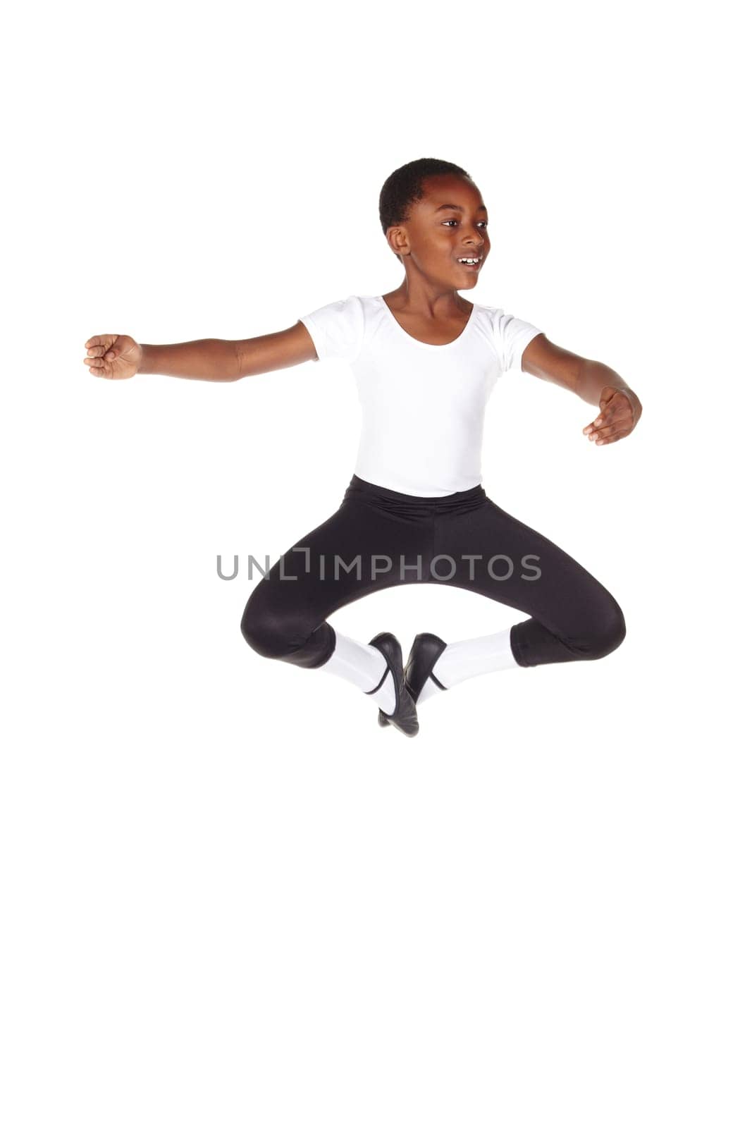 Young African ballet boy on white background and floor showing various ballet steps and positions. Not Isolated