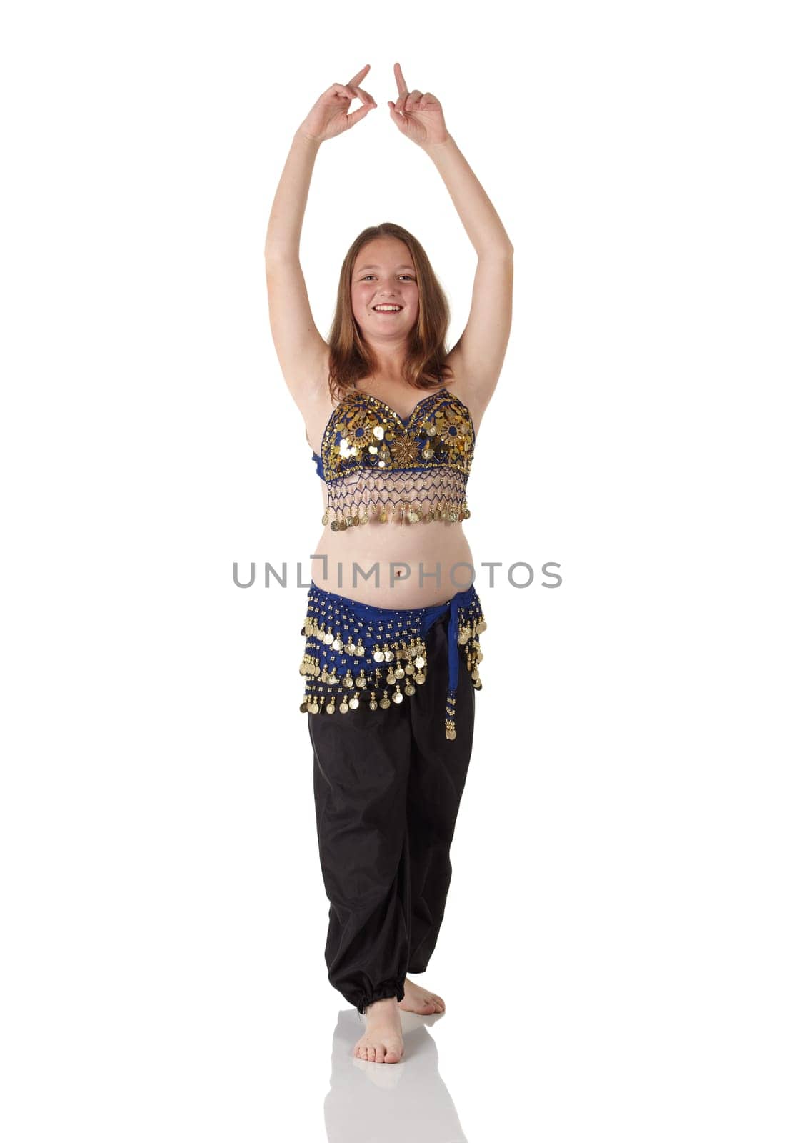 Young Caucasian belly dancing girl in beautiful decorated clothes on white background and reflective floor. Not isolated