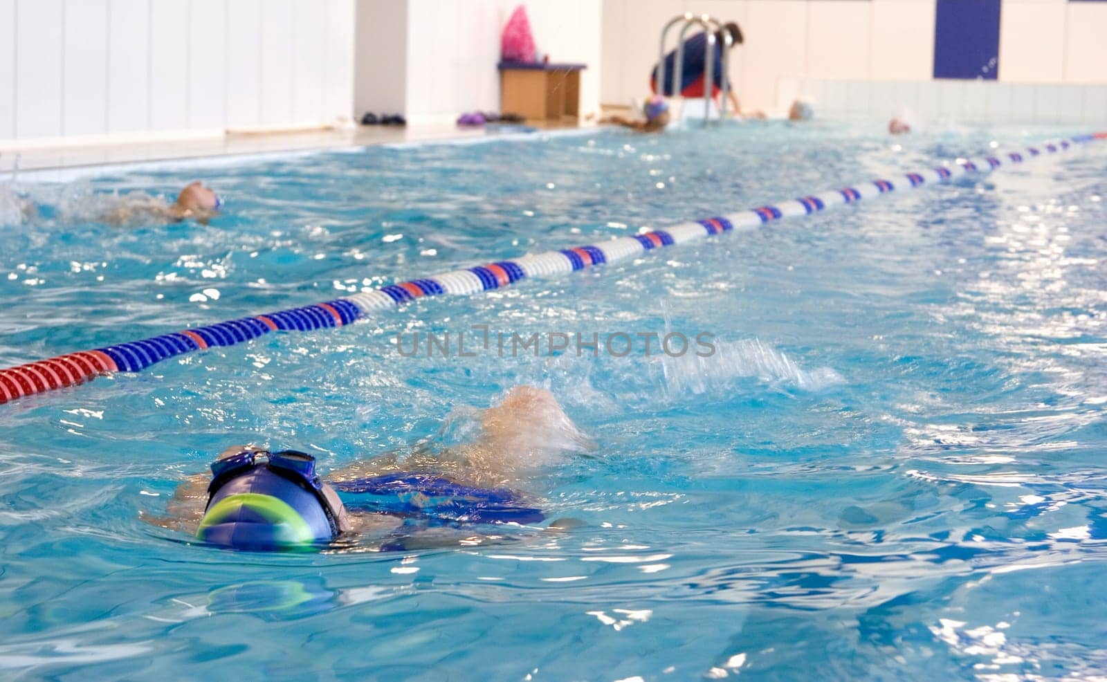 Training in swimming pool with turquoise-colored water