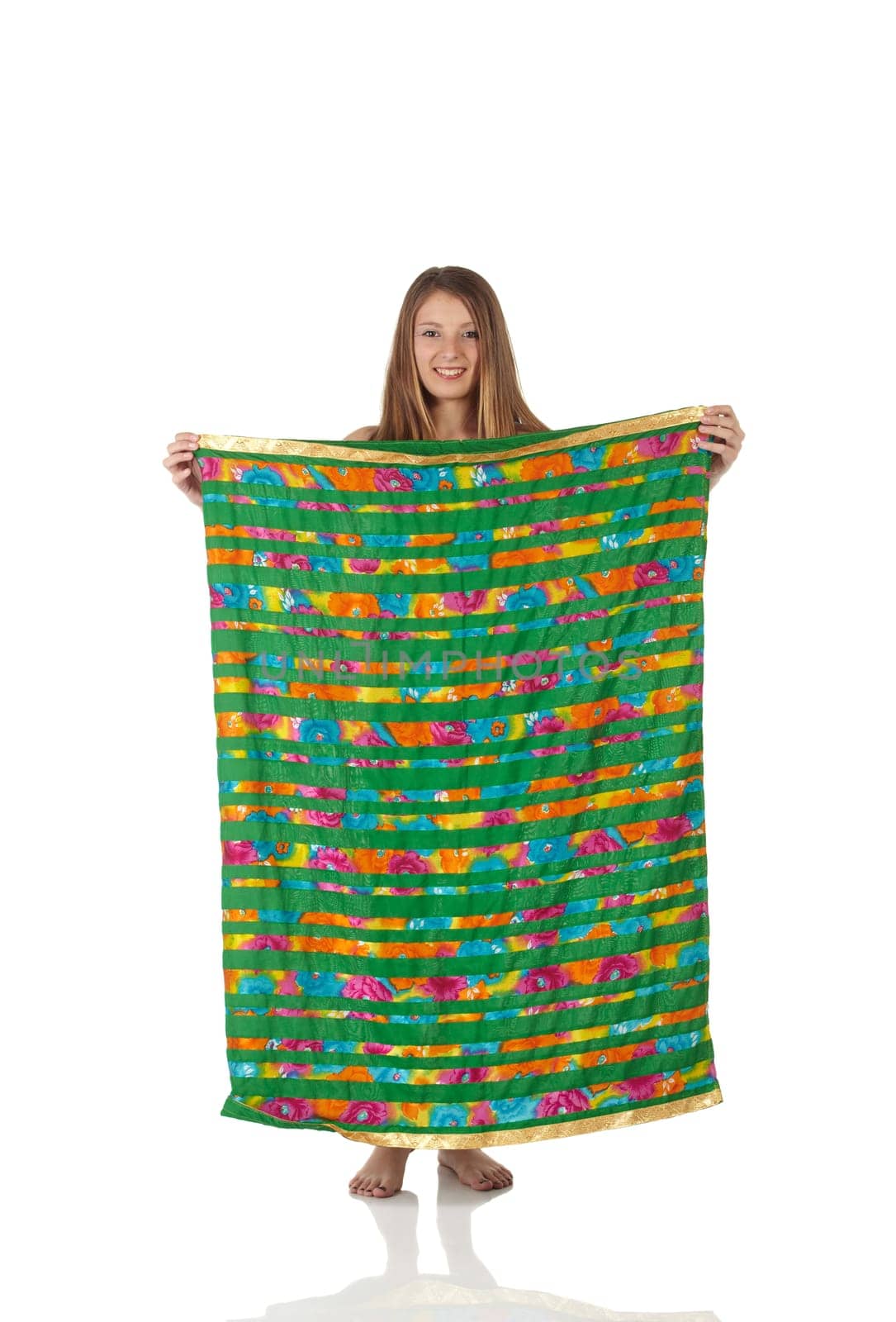 Young Caucasian belly dancing girl in beautiful decorated clothes on white background and reflective floor. Not isolated