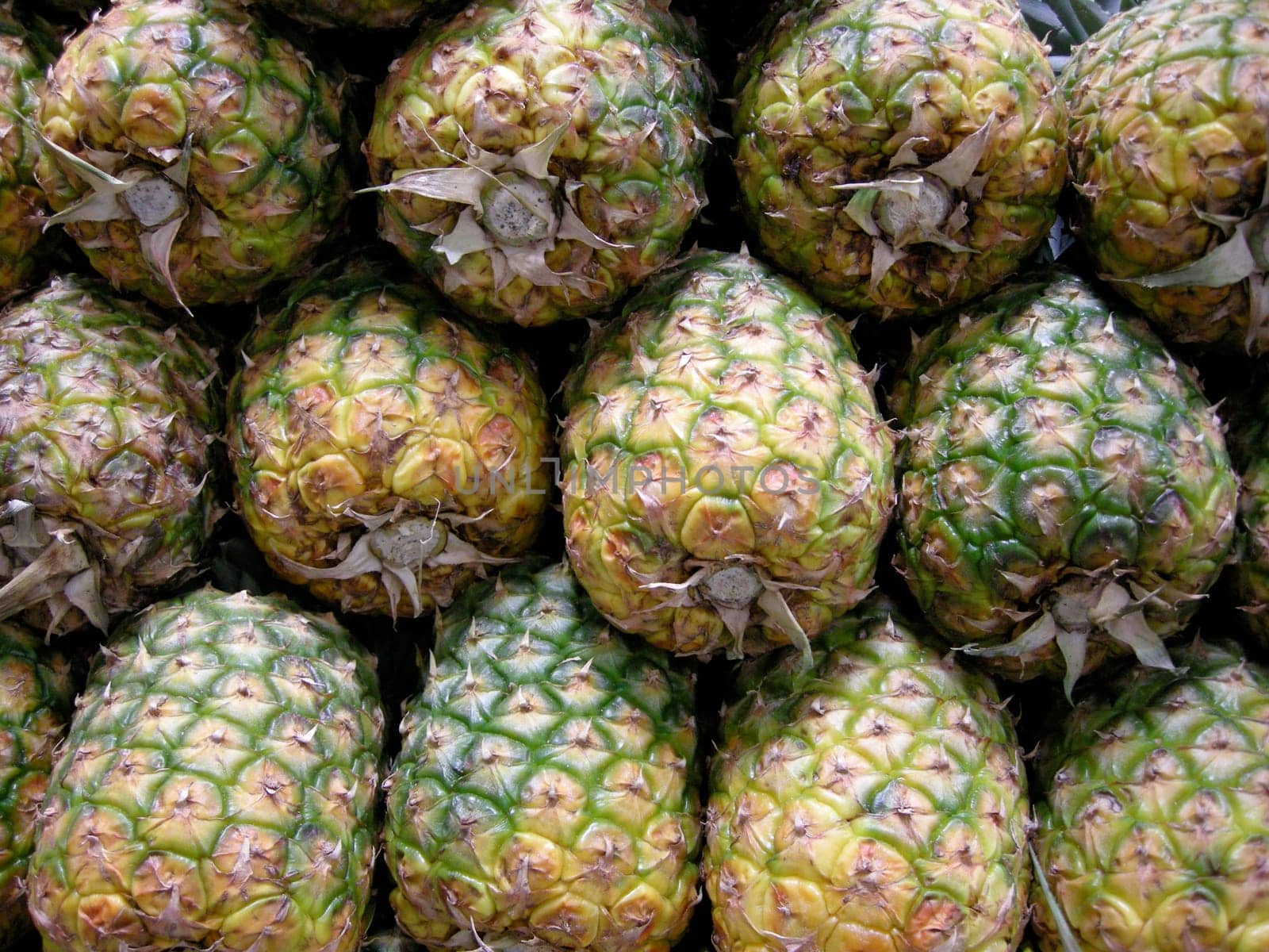 Stock photo of a stack of pineapples in a marketplace