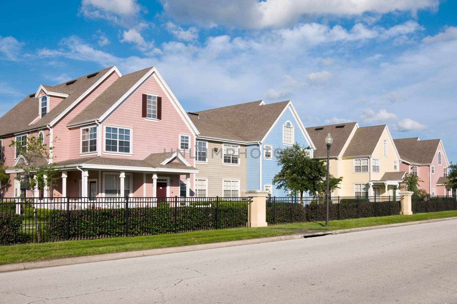 Colorful fenced in row houses with blue sky